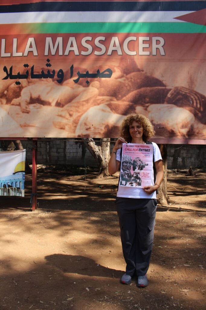 Director Carol Mansour holding Al Ard poster